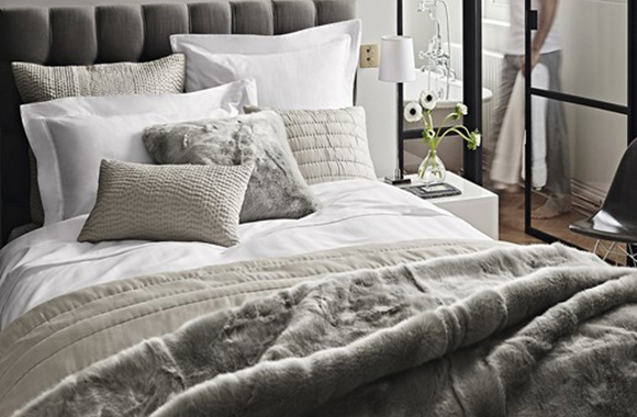 Luxury coverlets and throws on a beautifully styled bed